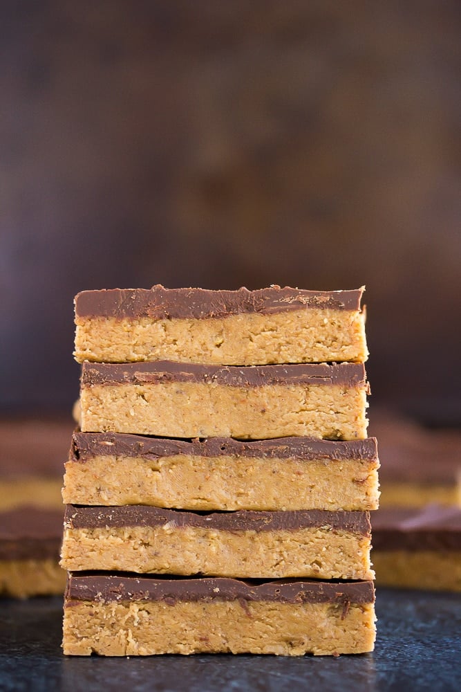 stack of vegan chocolate peanut butter bars with dark background