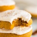 close up of a vegan pumpkin cookie with a bite taken out of one.