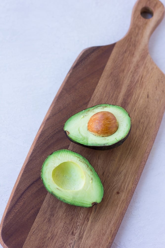 a sliced avocado on a cutting board