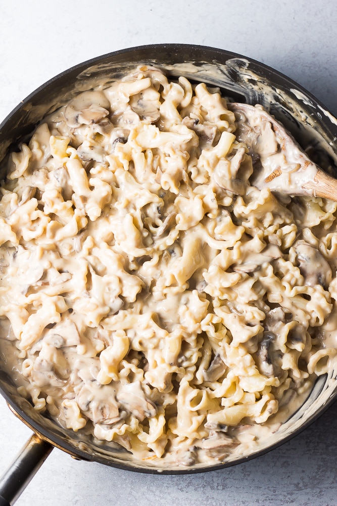 vegan mushroom stroganoff in a pan being stirred