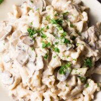 close up photo of mushroom stroganoff with parsley sprinkled on top