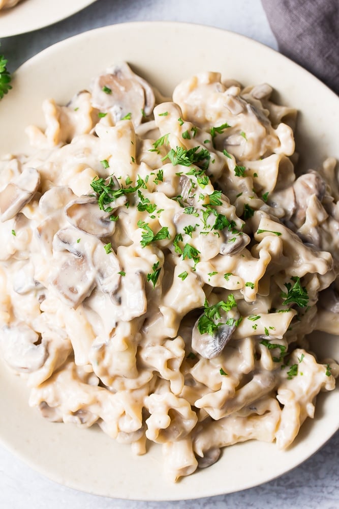 close up photo of mushroom stroganoff with parsley sprinkled on top