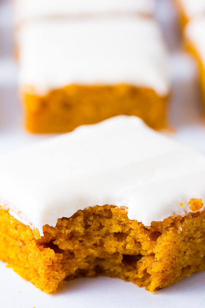 close up shot of a vegan pumpkin cake slice with a bite taken out