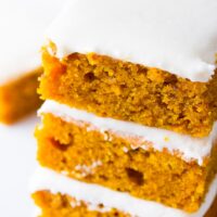 stack of 3 pumpkin bars with frosting