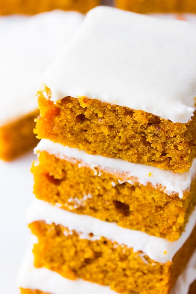 stack of 3 pumpkin bars with frosting