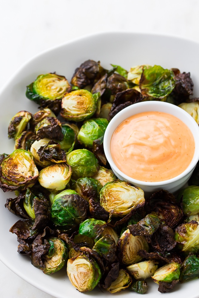 brussels sprouts on a plate with pink sauce