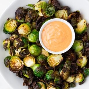 brussels sprouts on a plate with pink sauce