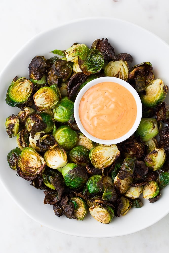 brussels sprouts on a plate with pink sauce