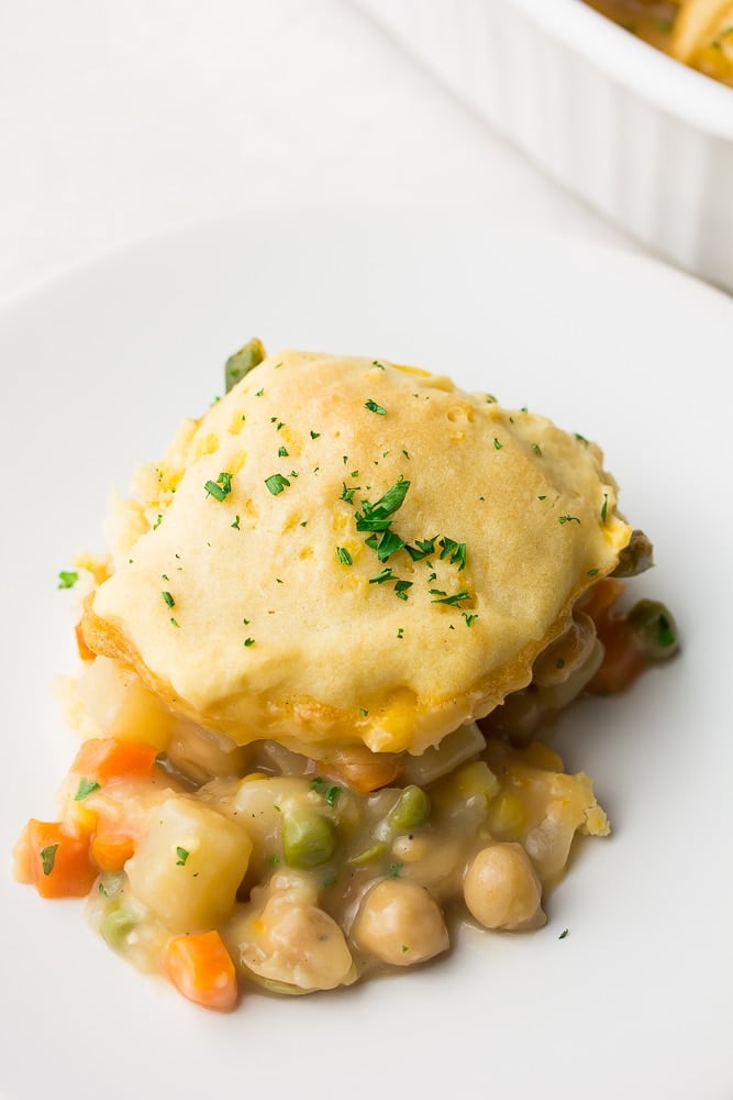 piece of biscuit topped pot pie on white plate