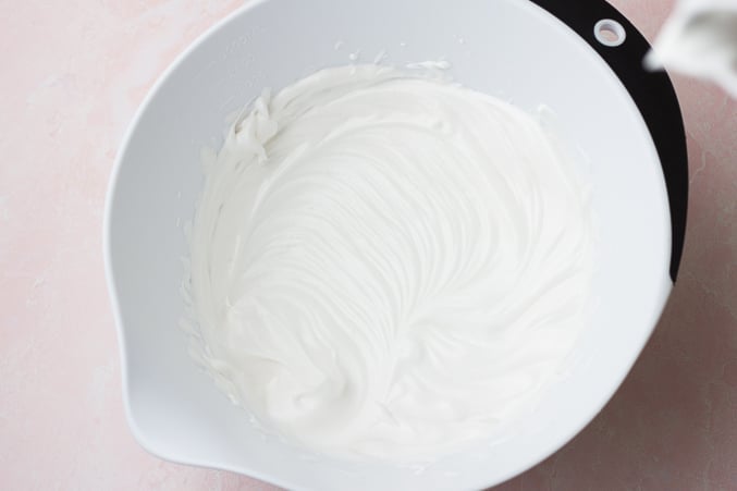 white bowl with whipped cream after beating