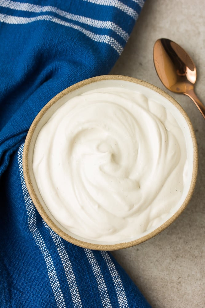 creamy sauce in a small bowl with blue towel by it