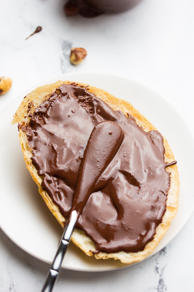 nutella being spread on a piece of bread
