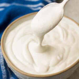 square image of creamy sauce in bowl, blue towel