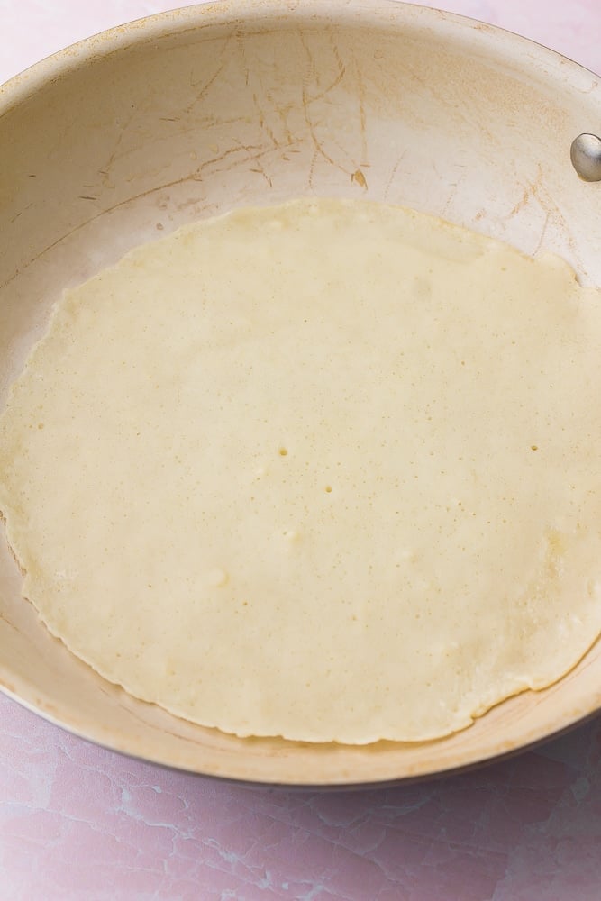 vegan crepe in a pan cooking