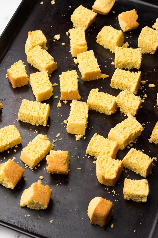 showing cubes of cornbread on a pan