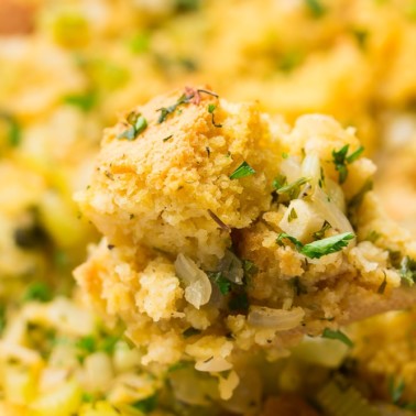 cornbread stuffing on a spoon with casserole in background