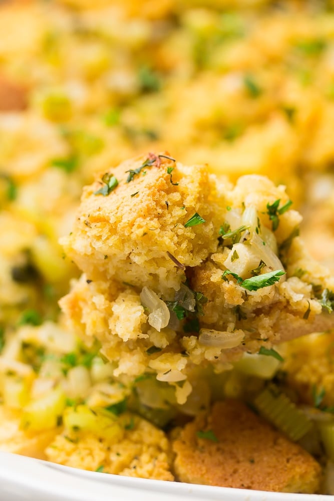 cornbread stuffing on a spoon with casserole in background