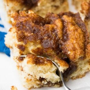 fork taking a bite of vegan coffee cake and blue towel