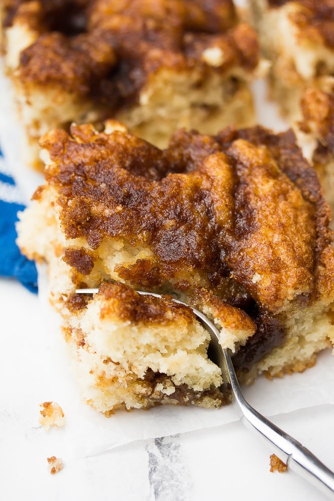 fork taking a bite of vegan coffee cake and blue towel