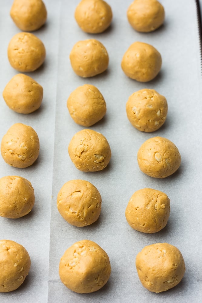 peanut butter balls on parchment paper