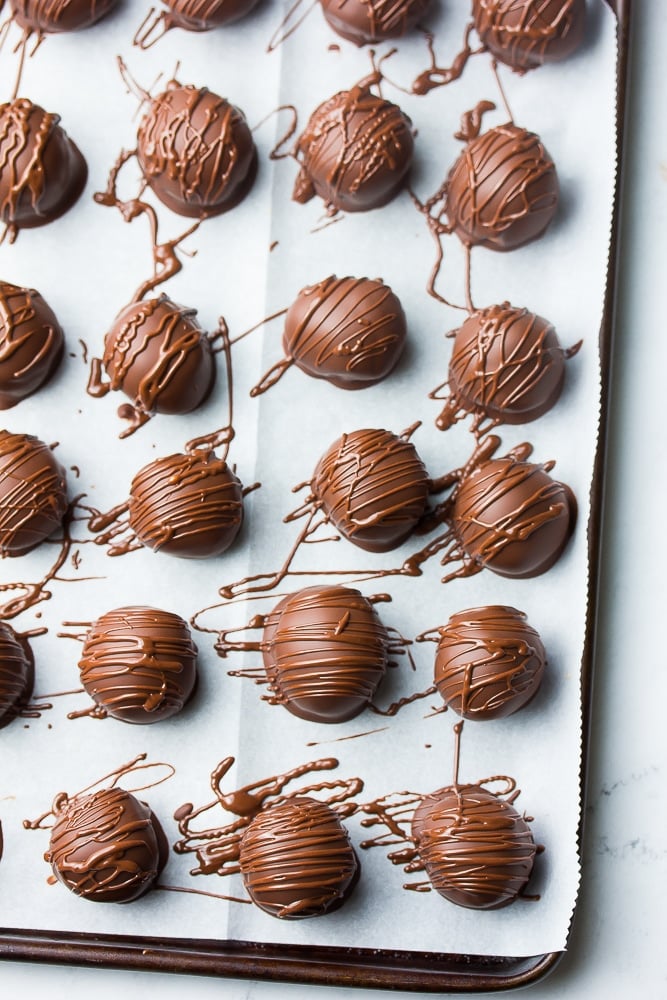 chocolate balls being drizzled with more melted chocolate