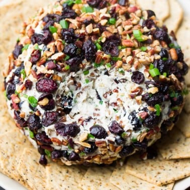 an area of the cheese ball is taken out showing creamy white inside