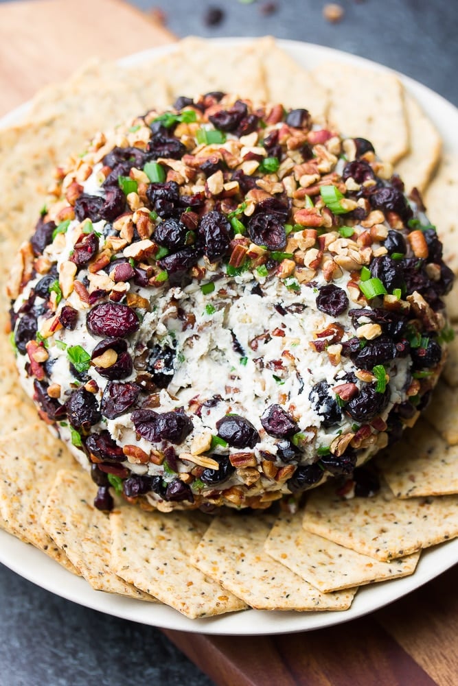 an area of the cheese ball is taken out showing creamy white inside