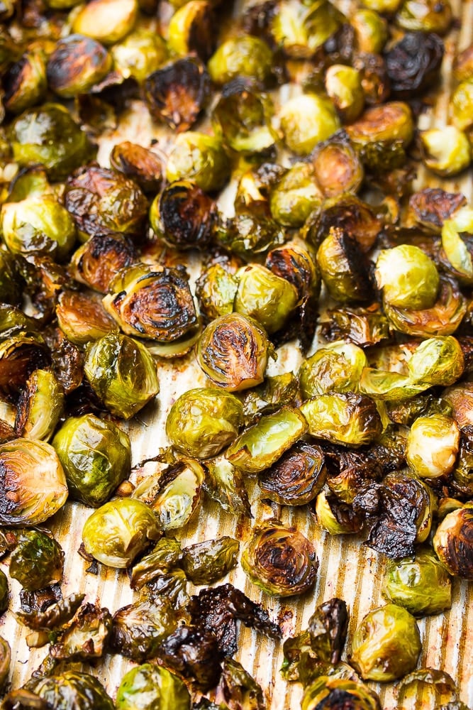 roasted brussels sprouts on a pan, cooked and crispy, brown in places