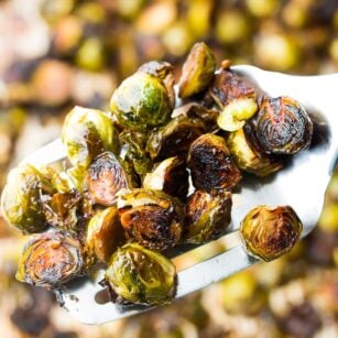 a spatula holding some roasted brussels sprouts