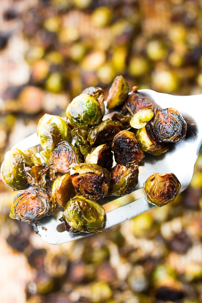 a spatula holding some roasted brussels sprouts