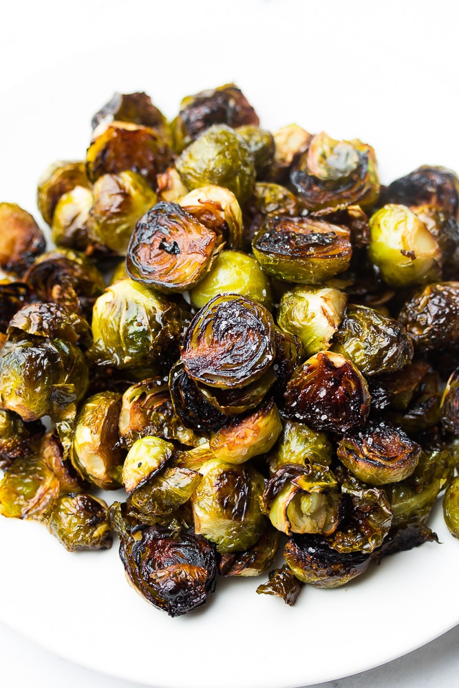 white plate with a big pile of brussels sprouts