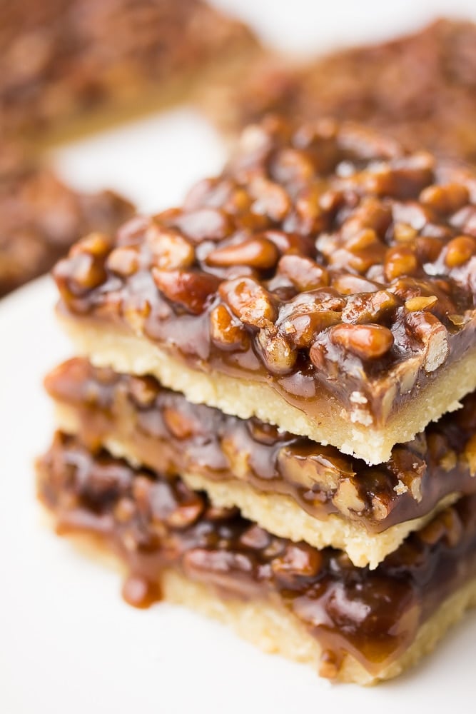 side shot of stacked vegan pecan bars