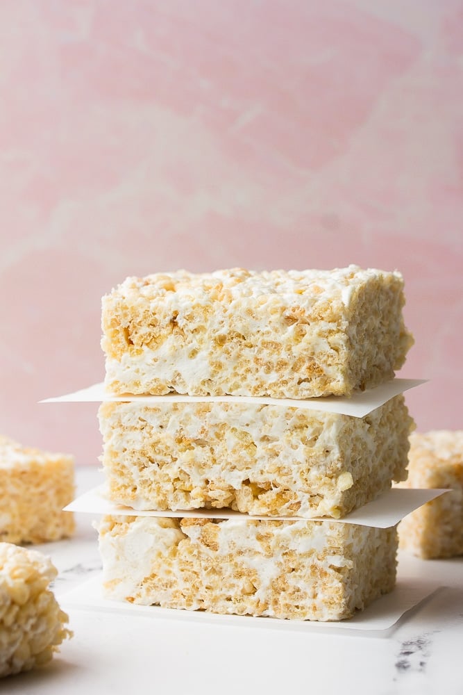 stack of rice krispie treats with pink background