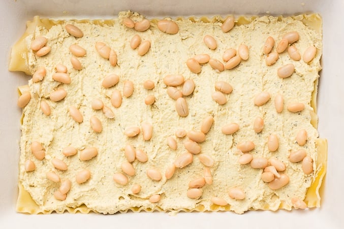 white beans sprinkled on a layer