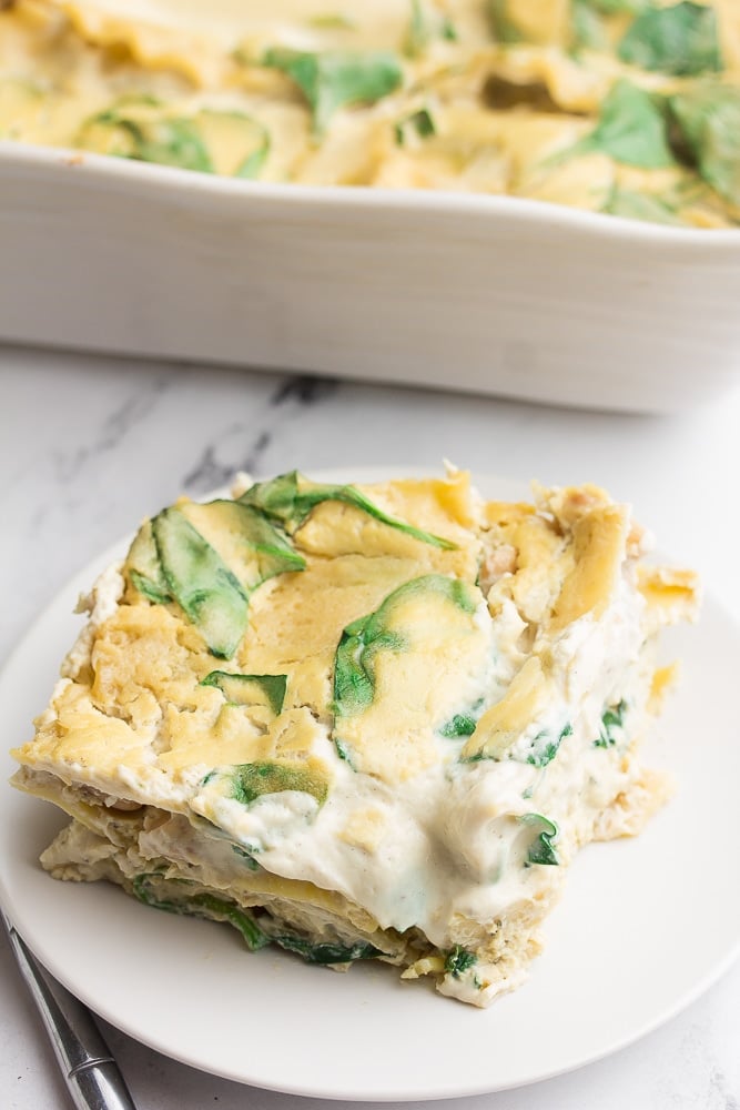 marble background, piece of white lasagna on white plate