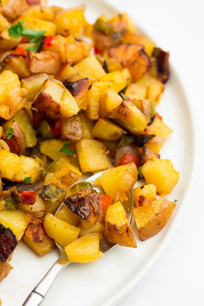 close up photo of cooked diced potatoes on a plate