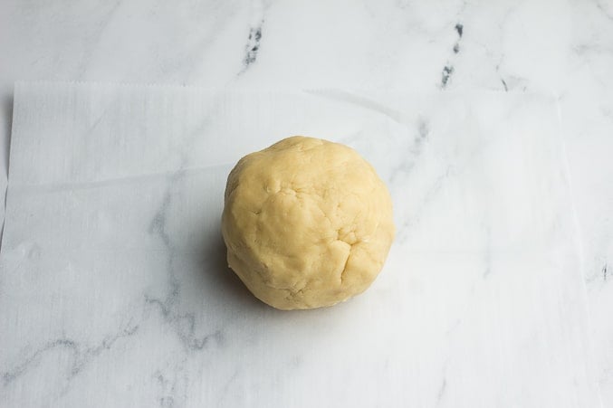 ball of cookie dough on parchment paper