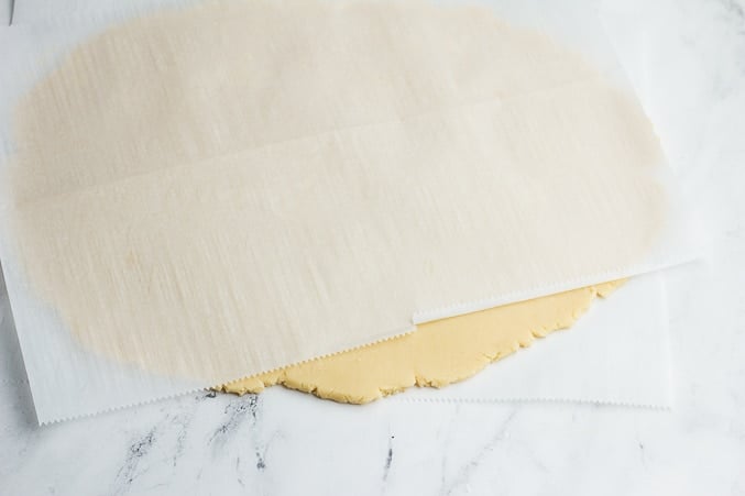 rolled vegan shortbread cookie dough with parchment paper