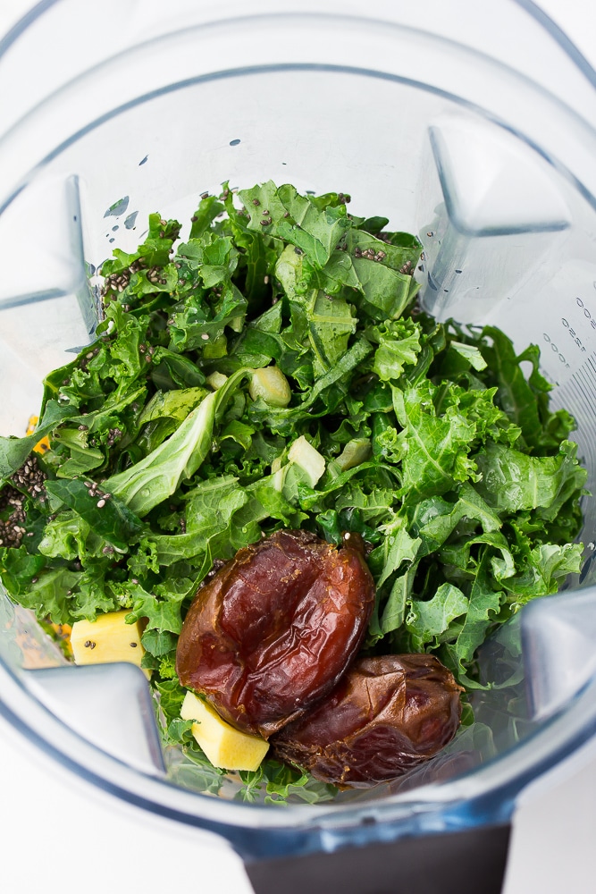 ingredients for kale smoothie in blender before being blended