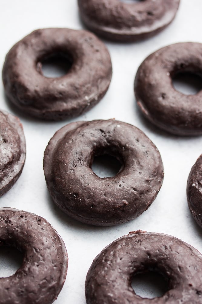 lots of chocolate donuts on grey background