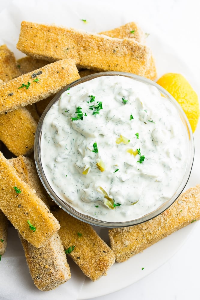 small bowl of vegan tartar sauce with tofu fish around it