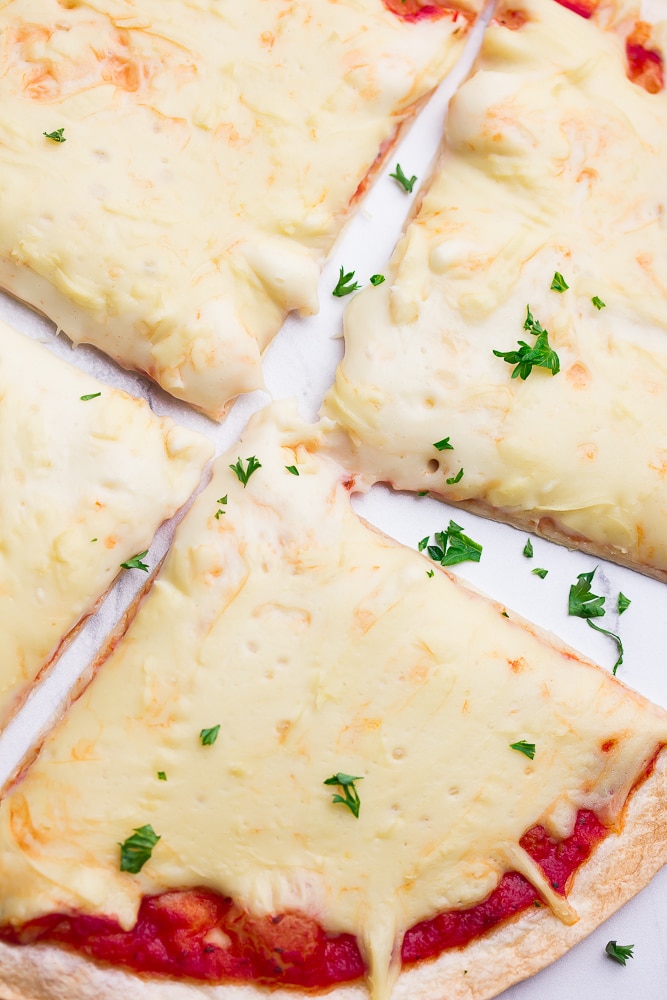 pizza, sliced, cut and close up with cheese and parsley