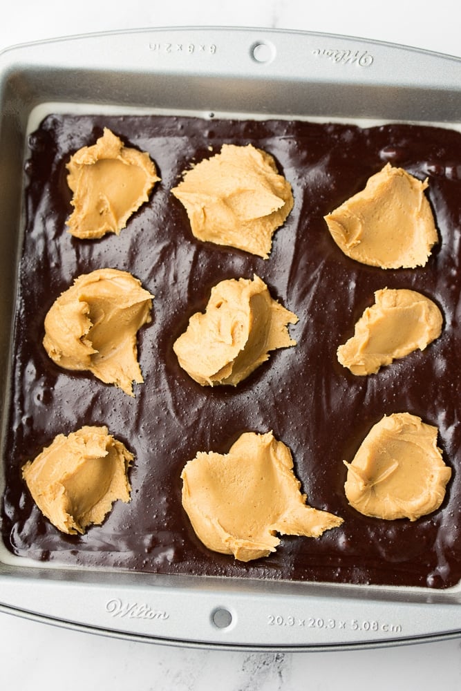 peanut butter dollops on brownie batter