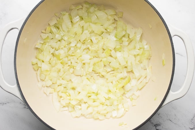 onions cooking in white pot