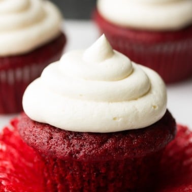 unwrapped red velvet cupcakes with more in back