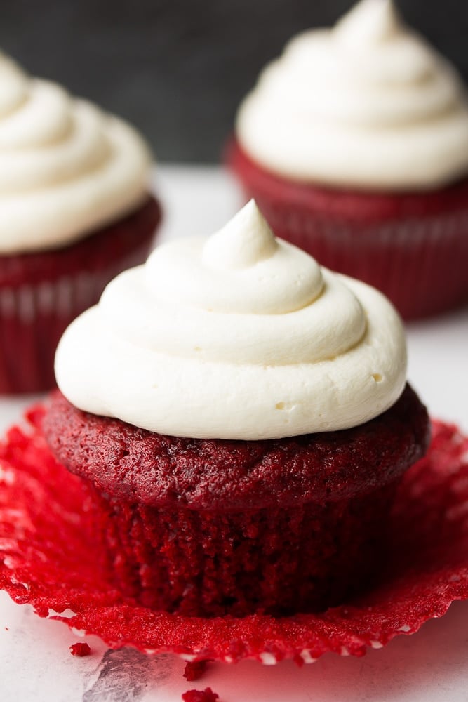 unwrapped red velvet cupcakes with more in back