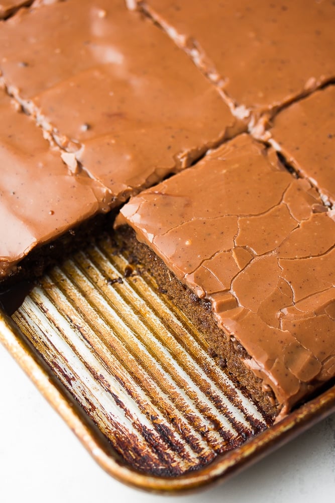 close up of pan of sheet cake with one slice removed