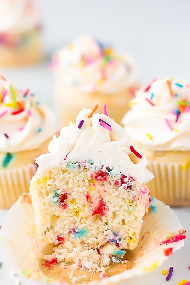 showing the middle of a cut cupcake with sprinkles