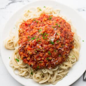 square image of spaghetti and red thick sauce