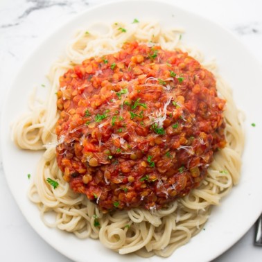 square image of spaghetti and red thick sauce